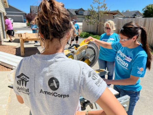 Americorps volunteer training Women Build volunteers at a tool learning station