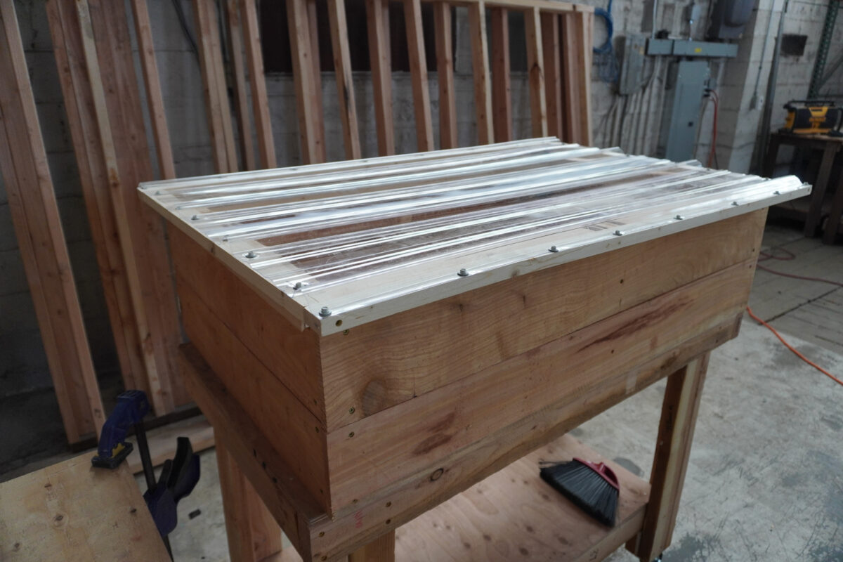 DIY planter box with transparent plastic hinged lid