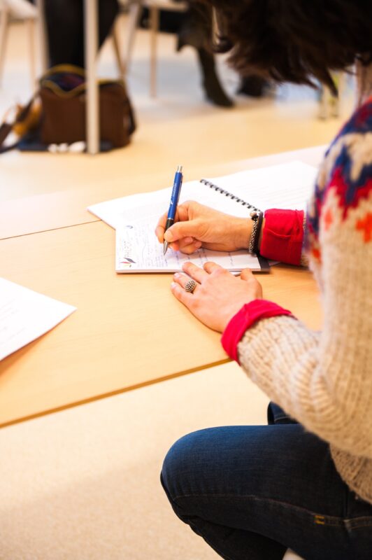 Financial coach taking notes during a meeting at Bend-Redmond Habitat for Humanity